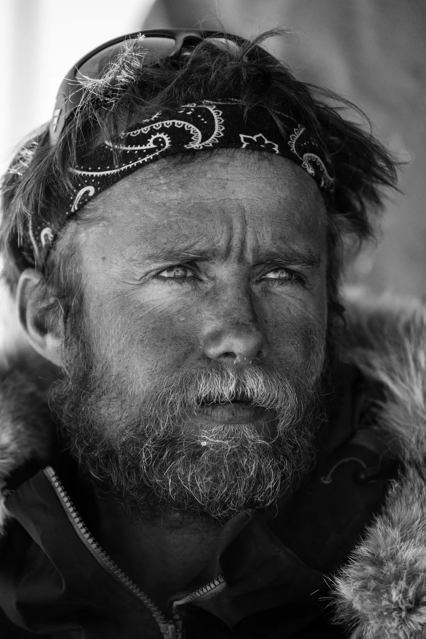 Leo Houlding, weathered and focused, wearing a bandana and expedition jacket