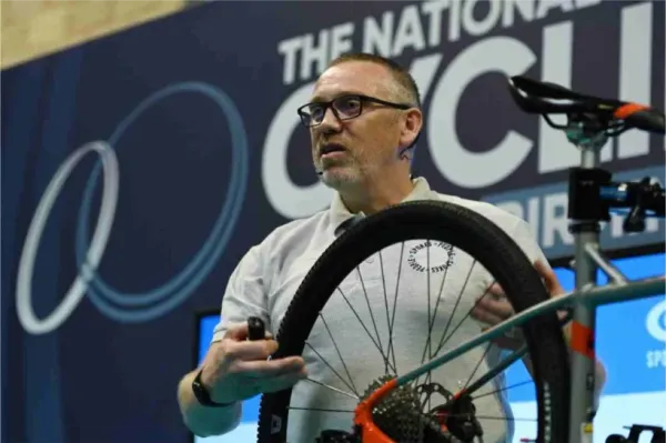 A mechanic demonstrating bike maintenance at The Bike Clinic