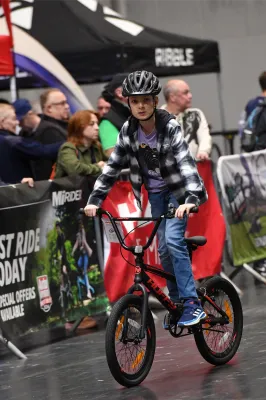 A young rider trying out a BMX bike in the demo area