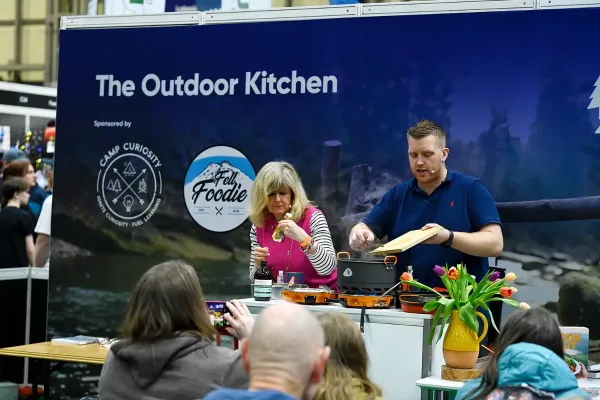 Presenters cooking on a camp stove at The Outdoor Kitchen